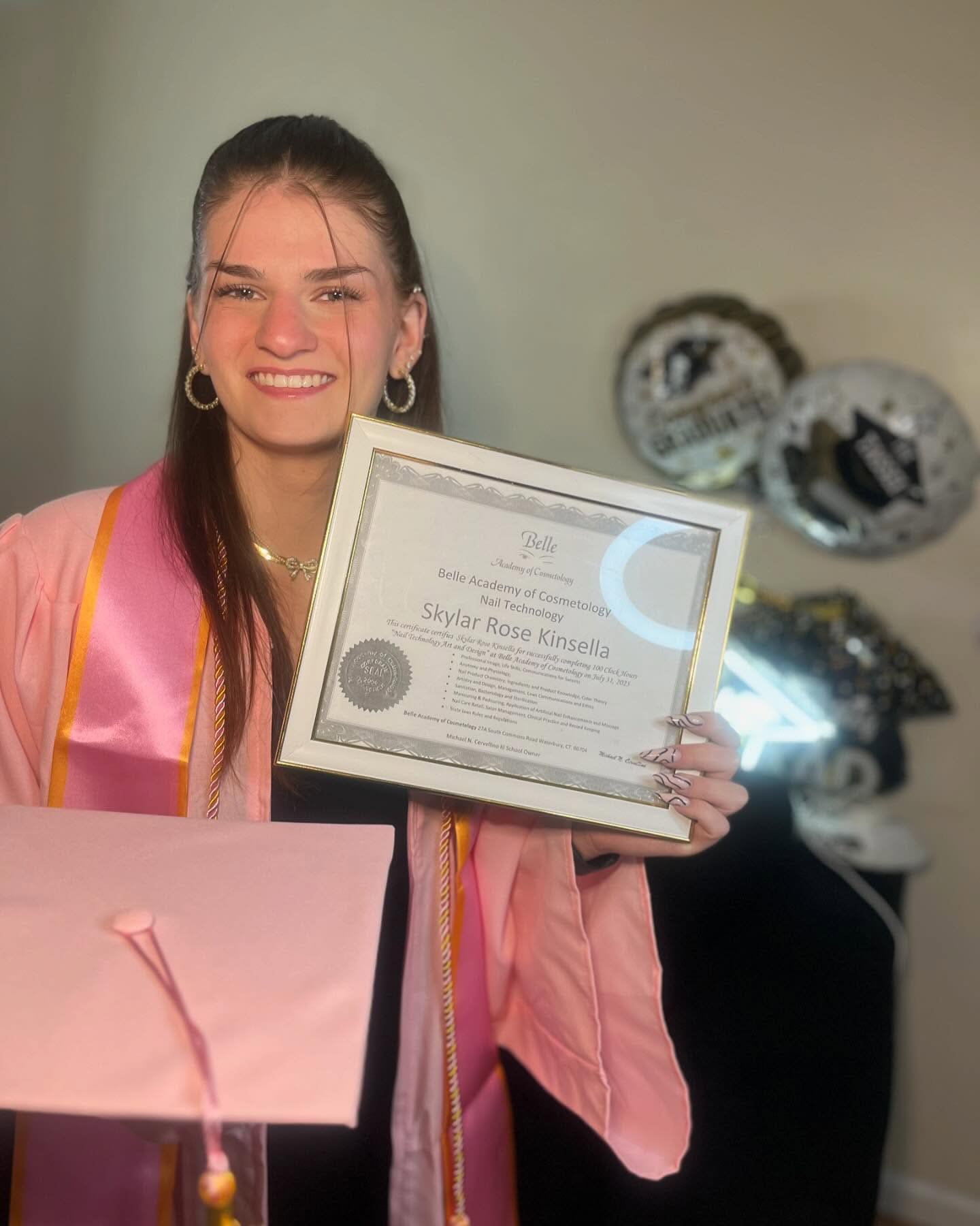 Nail tech graduate with certificate and gift bag