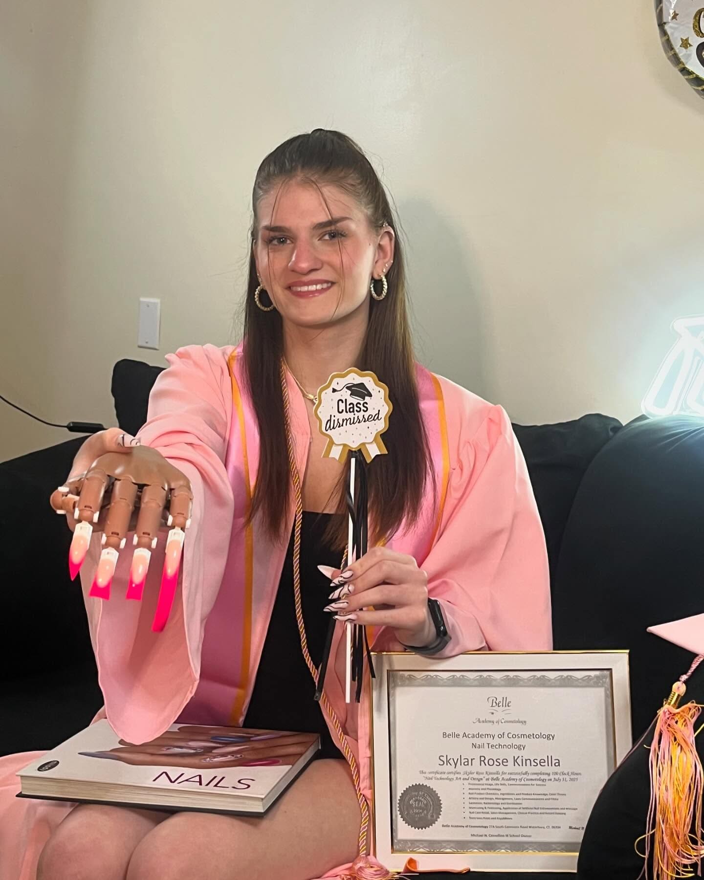 Nail tech graduate with certificate and manicure showcase
